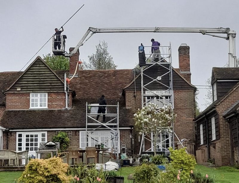 The Roof Moss Cleaners using cherry picker and scaffolding to clean roof safely and professionally in St Ives, Cambridgeshire