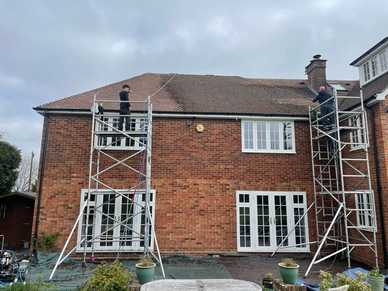 Roof cleaning carried out safely from scaffold towers by The Roof Moss Cleaners in St Ives